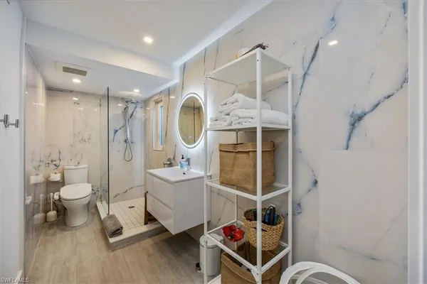 a bathroom with a toilet a sink and a mirror