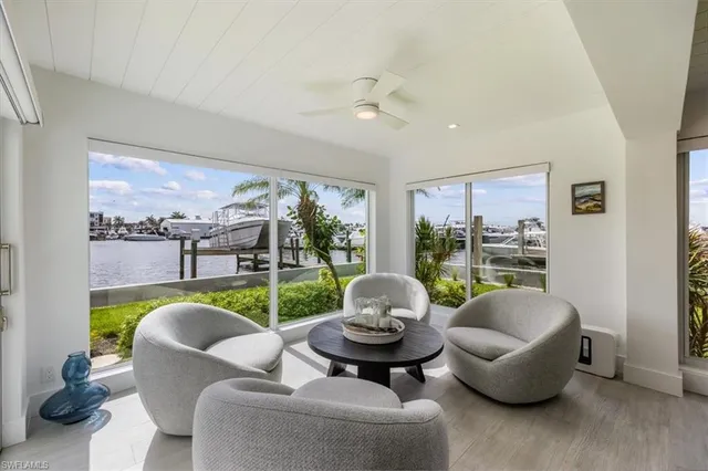 a living room with furniture and a floor to ceiling window
