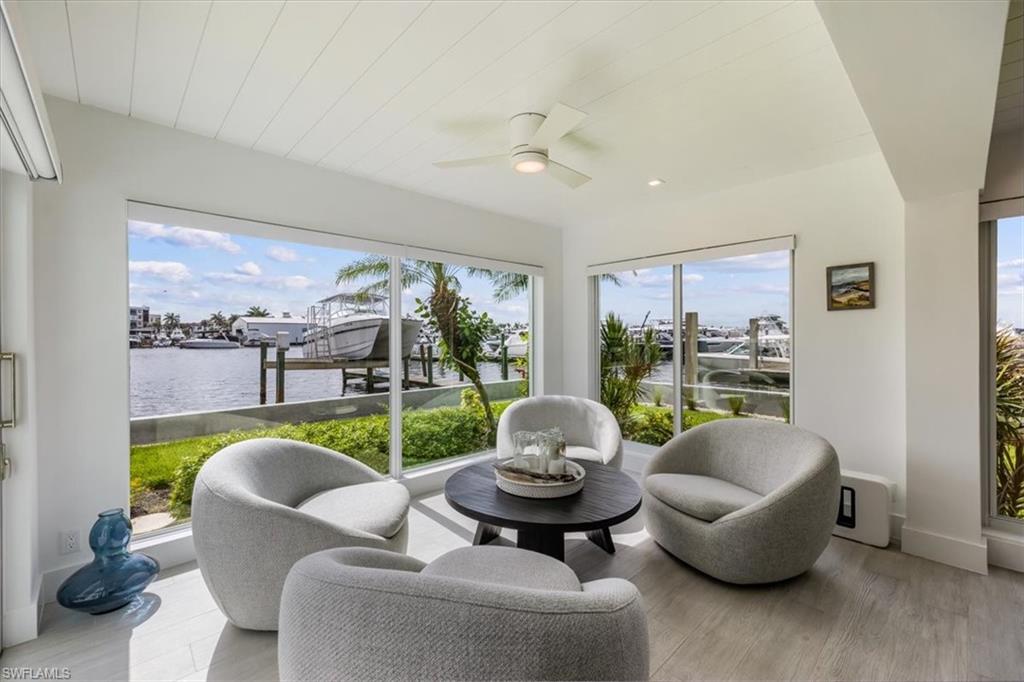 1100 8th Avenue South, Unit 123F Naples, FL 34102 - Photo 2 of 30 a living room with furniture and a floor to ceiling window