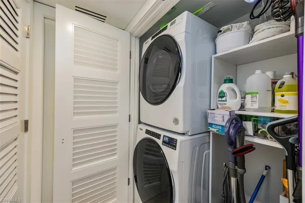 a patio with wooden floor a yard a table and chairs