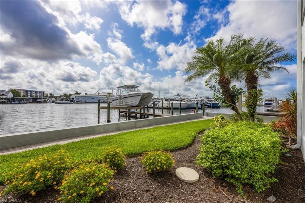 1100 8th Avenue South, Unit 123F Naples, FL 34102 - Photo 23 of 30 a view of a lake with a yard