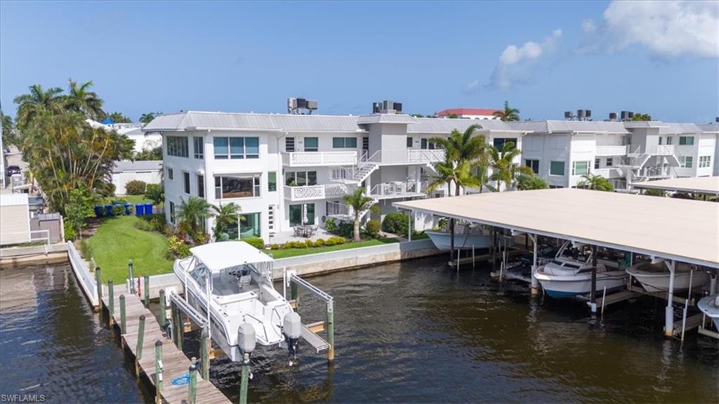 1100 8th Avenue South, Unit 123F Naples, FL 34102 - Photo 28 of 30 a view of a house with pool and chairs