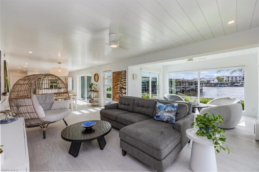1100 8th Avenue South, Unit 123F Naples, FL 34102 - Photo 4 of 30 a living room with furniture and a large window