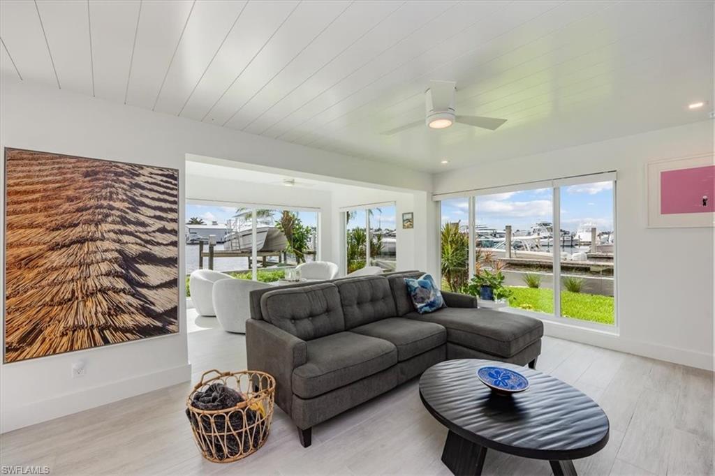 1100 8th Avenue South, Unit 123F Naples, FL 34102 - Photo 5 of 30 a living room with furniture and a large window