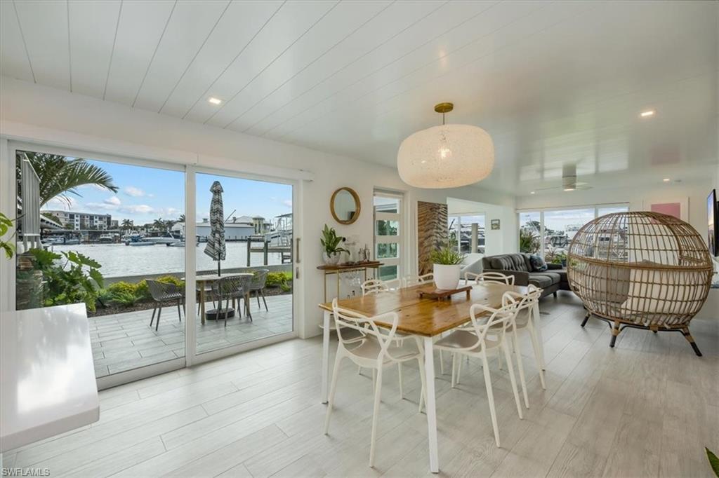 1100 8th Avenue South, Unit 123F Naples, FL 34102 - Photo 6 of 30 a living room with lots of furniture and a large mirror
