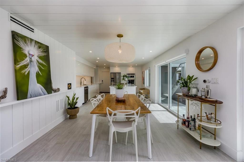 1100 8th Avenue South, Unit 123F Naples, FL 34102 - Photo 7 of 30 a view of a dining room with furniture window and wooden floor
