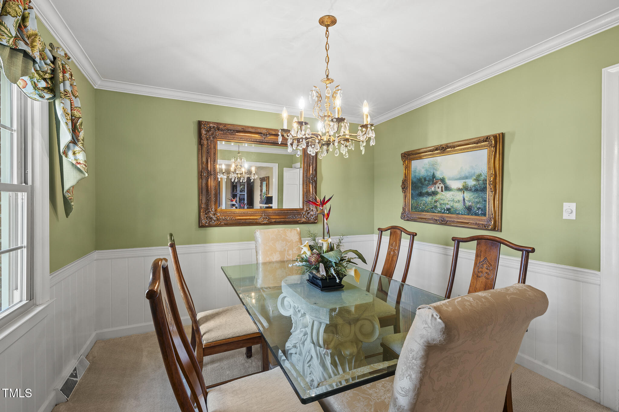 11801 Strickland Road Raleigh, NC 27613 - Photo 14 of 38 a view of a dining room with furniture wooden floor and chandelier