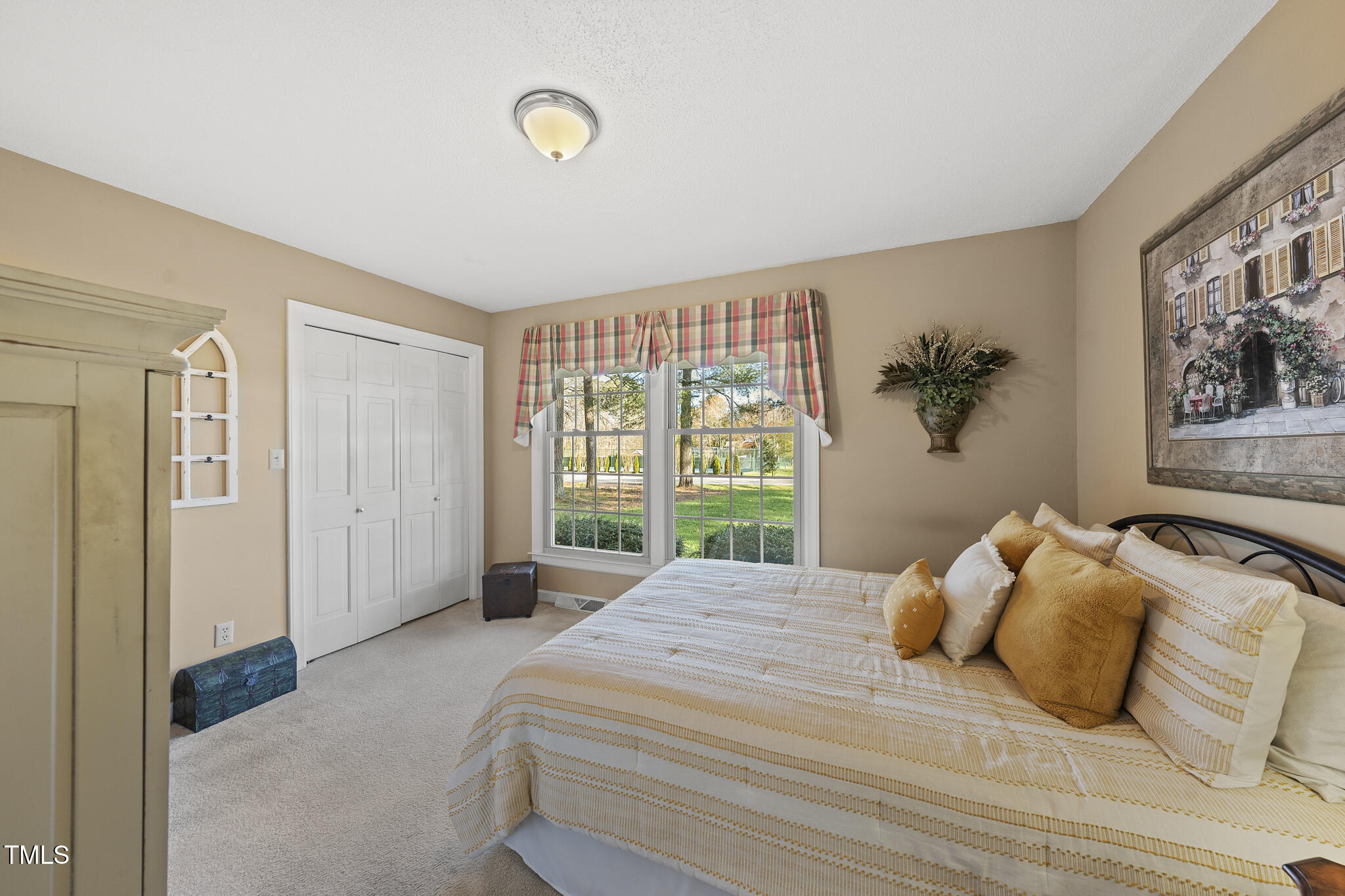 11801 Strickland Road Raleigh, NC 27613 - Photo 17 of 38 a bedroom with a large bed and a large window