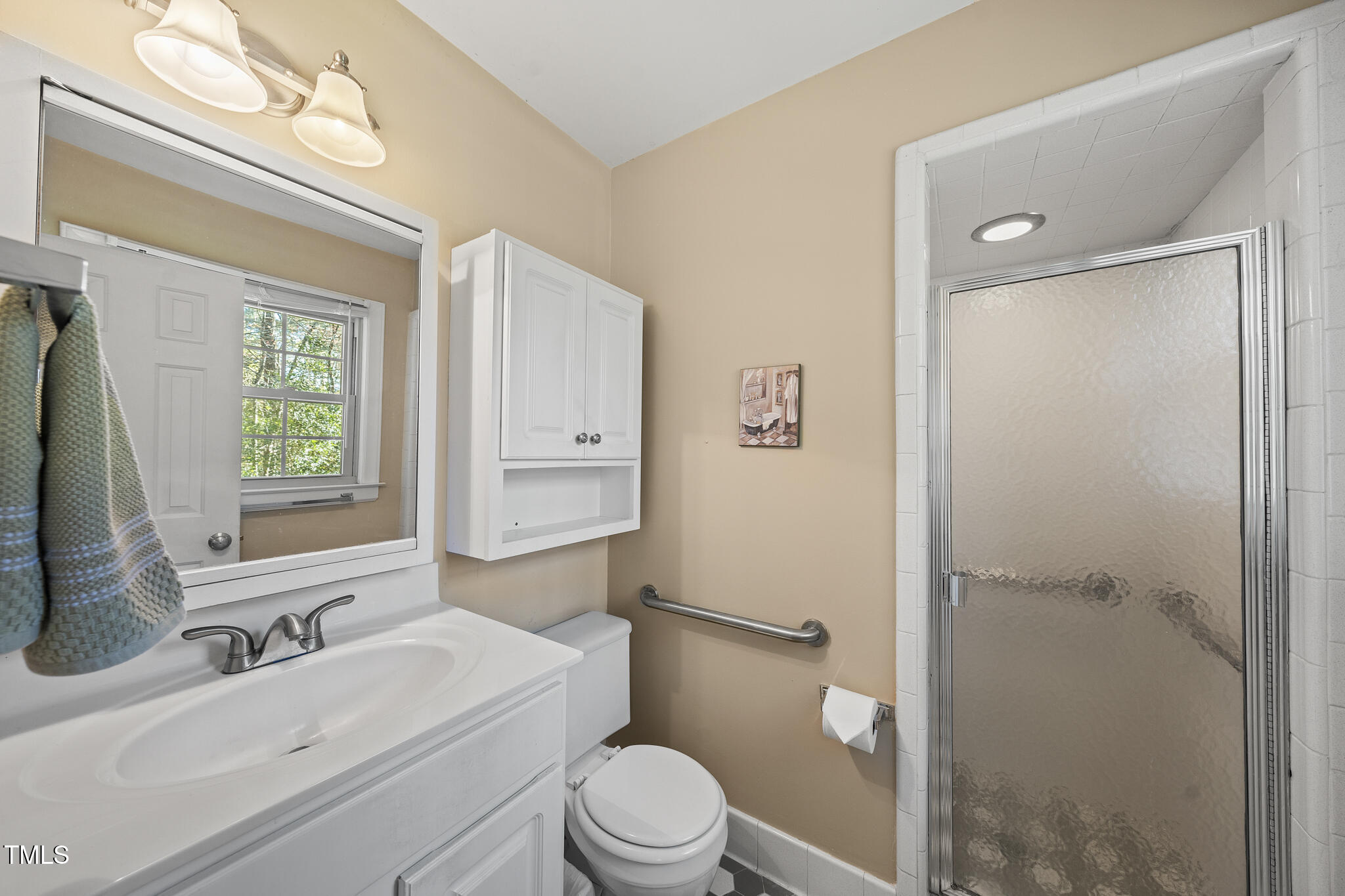 11801 Strickland Road Raleigh, NC 27613 - Photo 25 of 38 a bathroom with a sink a toilet and shower