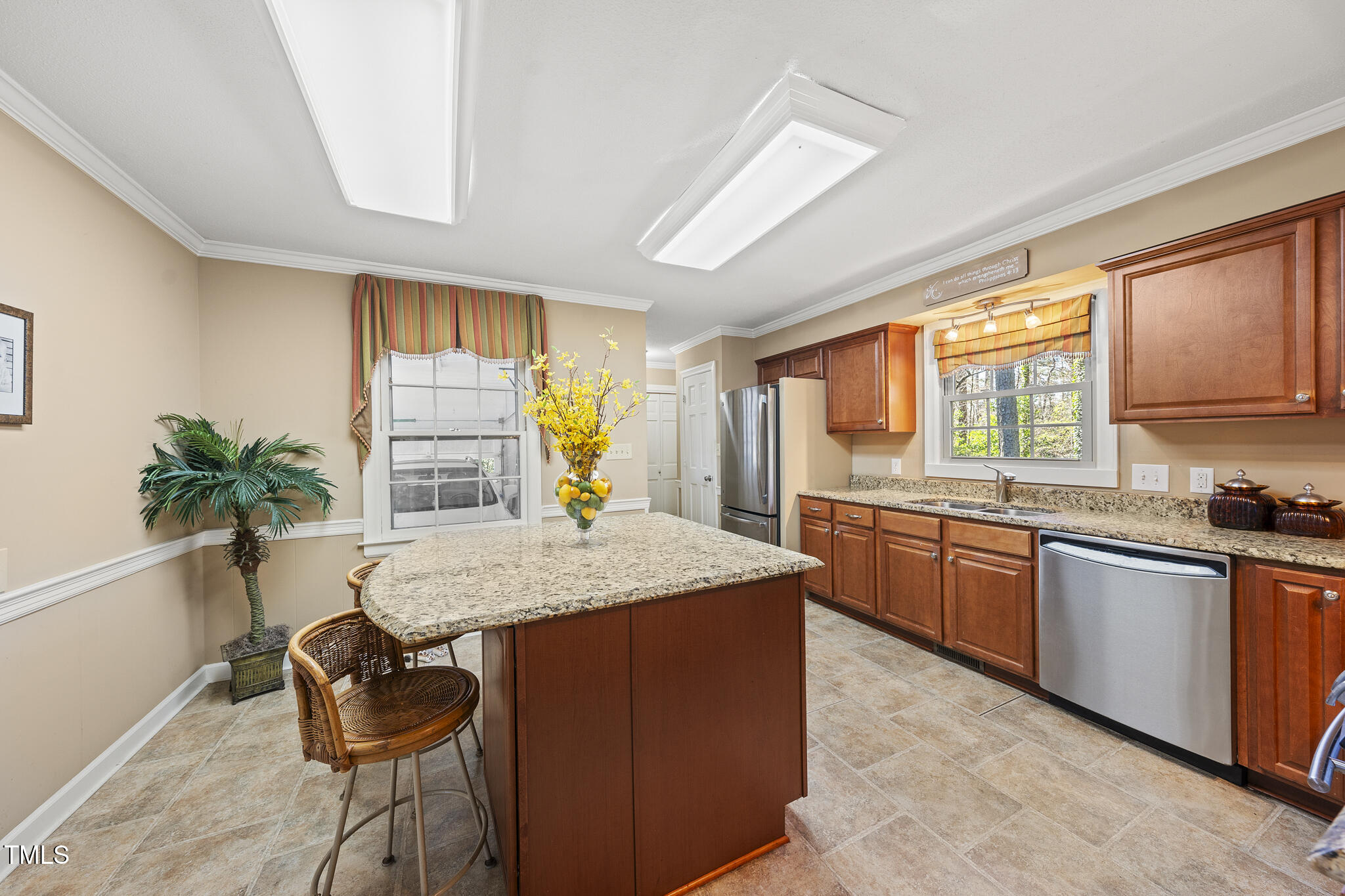 11801 Strickland Road Raleigh, NC 27613 - Photo 27 of 38 a kitchen with granite countertop sink stove and cabinets