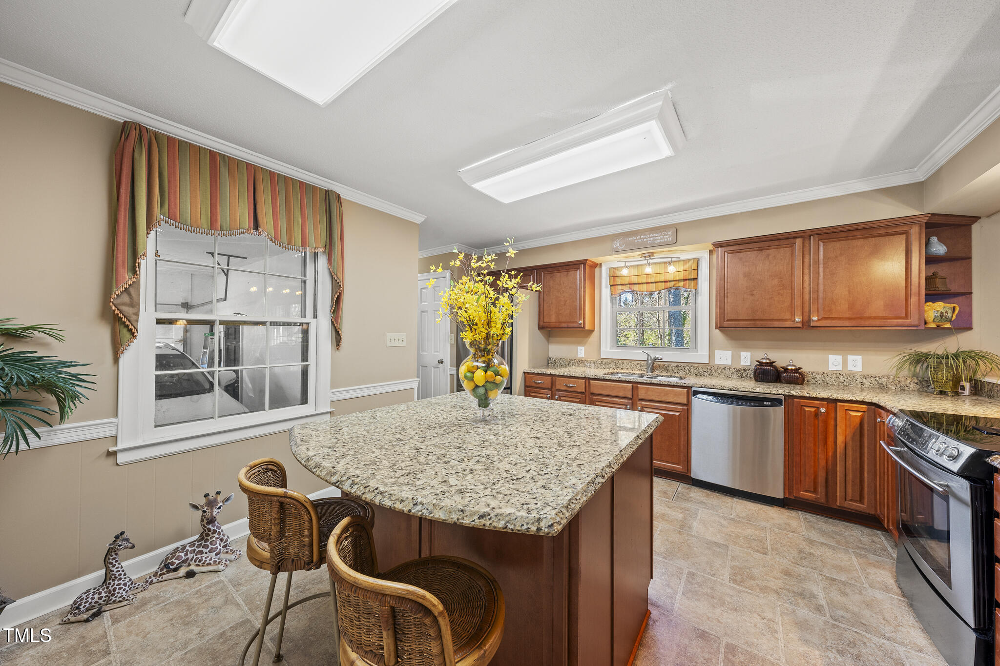 11801 Strickland Road Raleigh, NC 27613 - Photo 28 of 38 a kitchen with granite countertop wooden cabinets and stainless steel appliances
