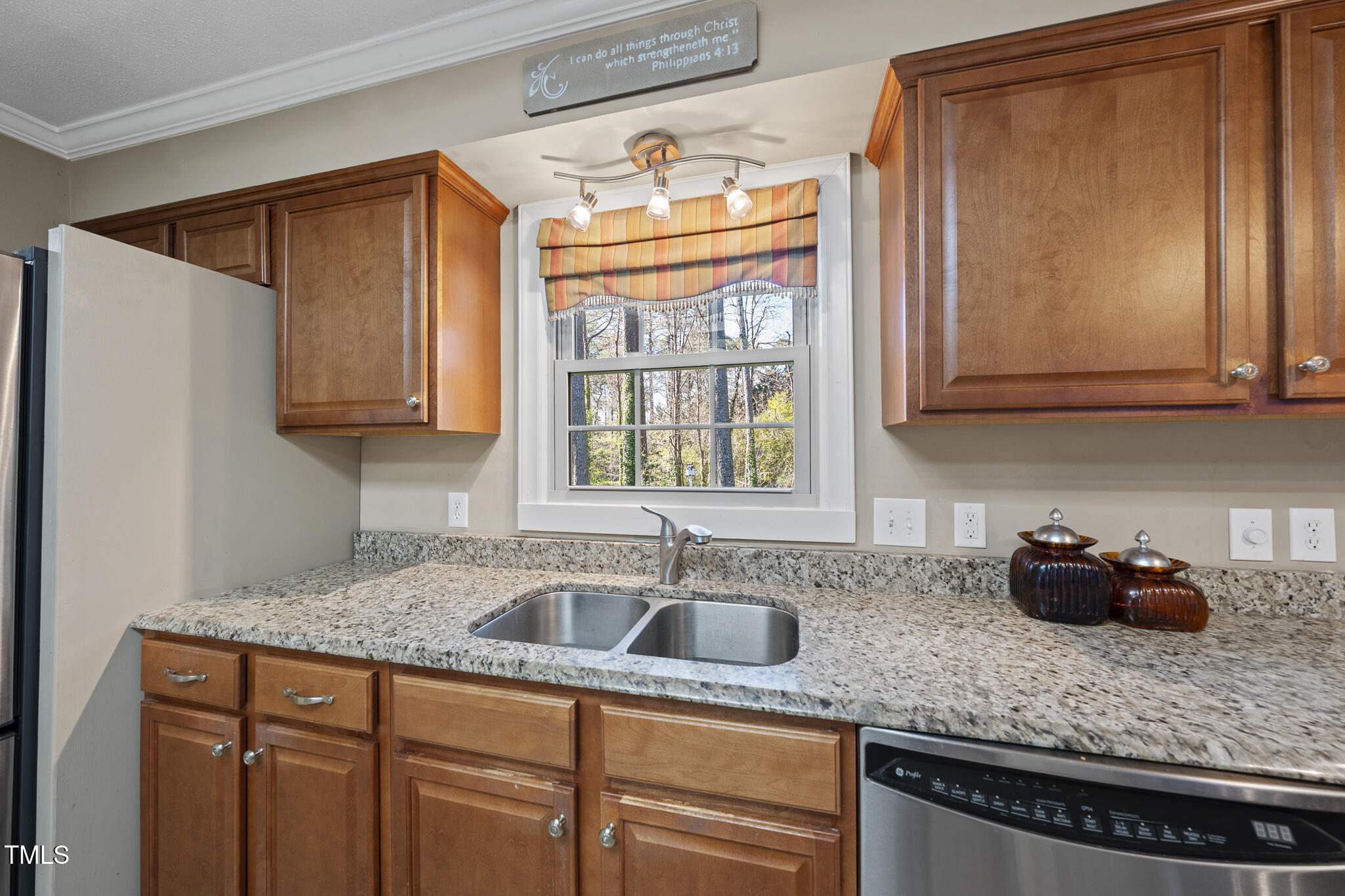 11801 Strickland Road Raleigh, NC 27613 - Photo 29 of 38 a kitchen with stainless steel appliances granite countertop a sink a stove and a microwave
