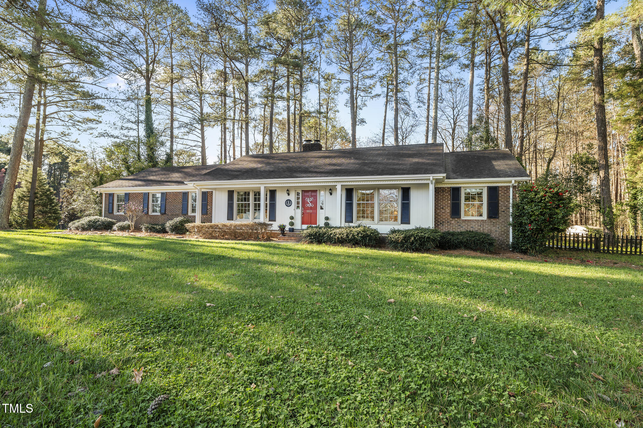 11801 Strickland Road Raleigh, NC 27613 - Photo 2 of 38 a front view of a house with a garden