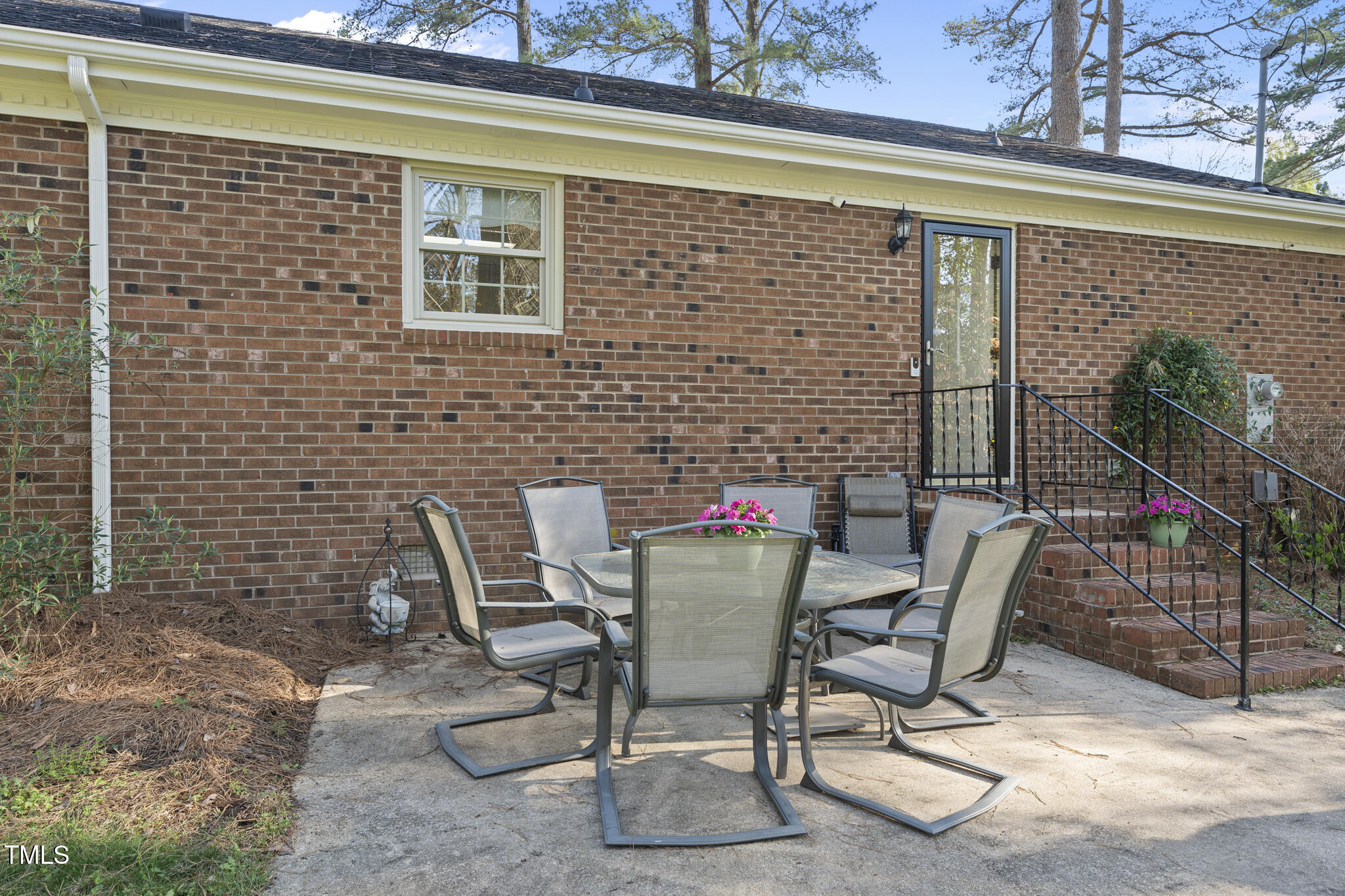 11801 Strickland Road Raleigh, NC 27613 - Photo 35 of 38 a patio with table and chairs and potted plants
