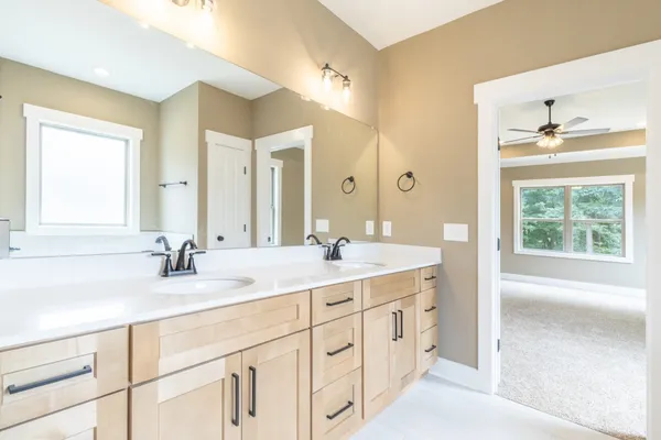 a bathroom with a double vanity sink a mirror and a