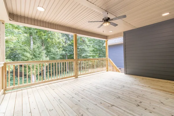 a view of backyard with a ceiling fan and wooden floor