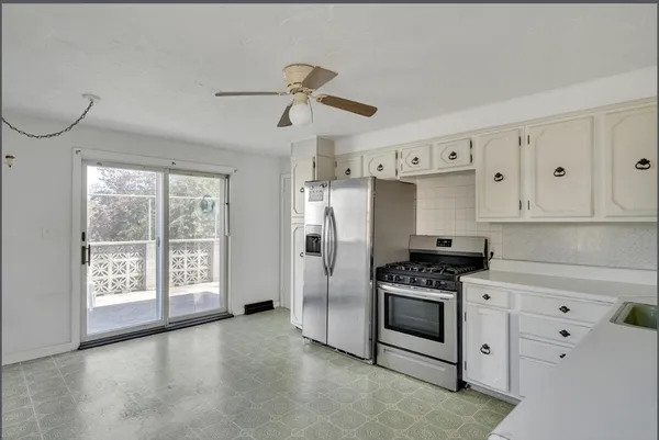 a kitchen with stainless steel appliances a refrigerator sink and cabinets