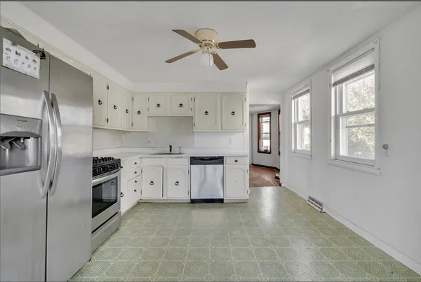 a kitchen with stainless steel appliances granite countertop a stove and a refrigerator