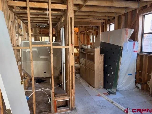 a view of a room with wooden floor and windows