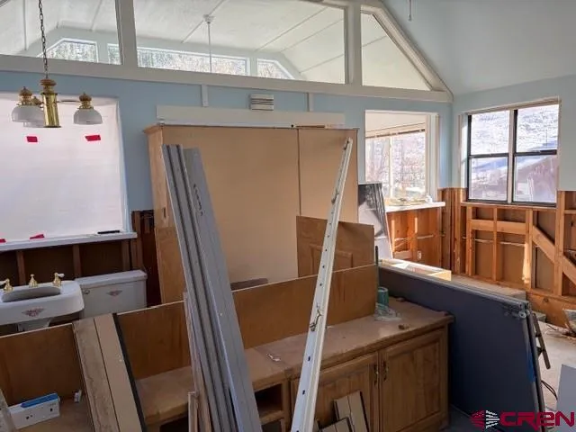 a view of a living room with a window and wooden floors