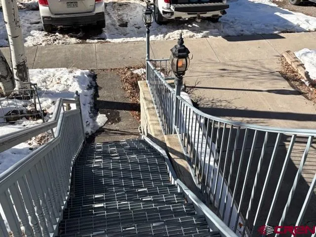 a view of a balcony with wooden fence