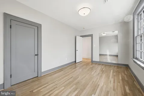 a spacious bedroom with a bed and a window