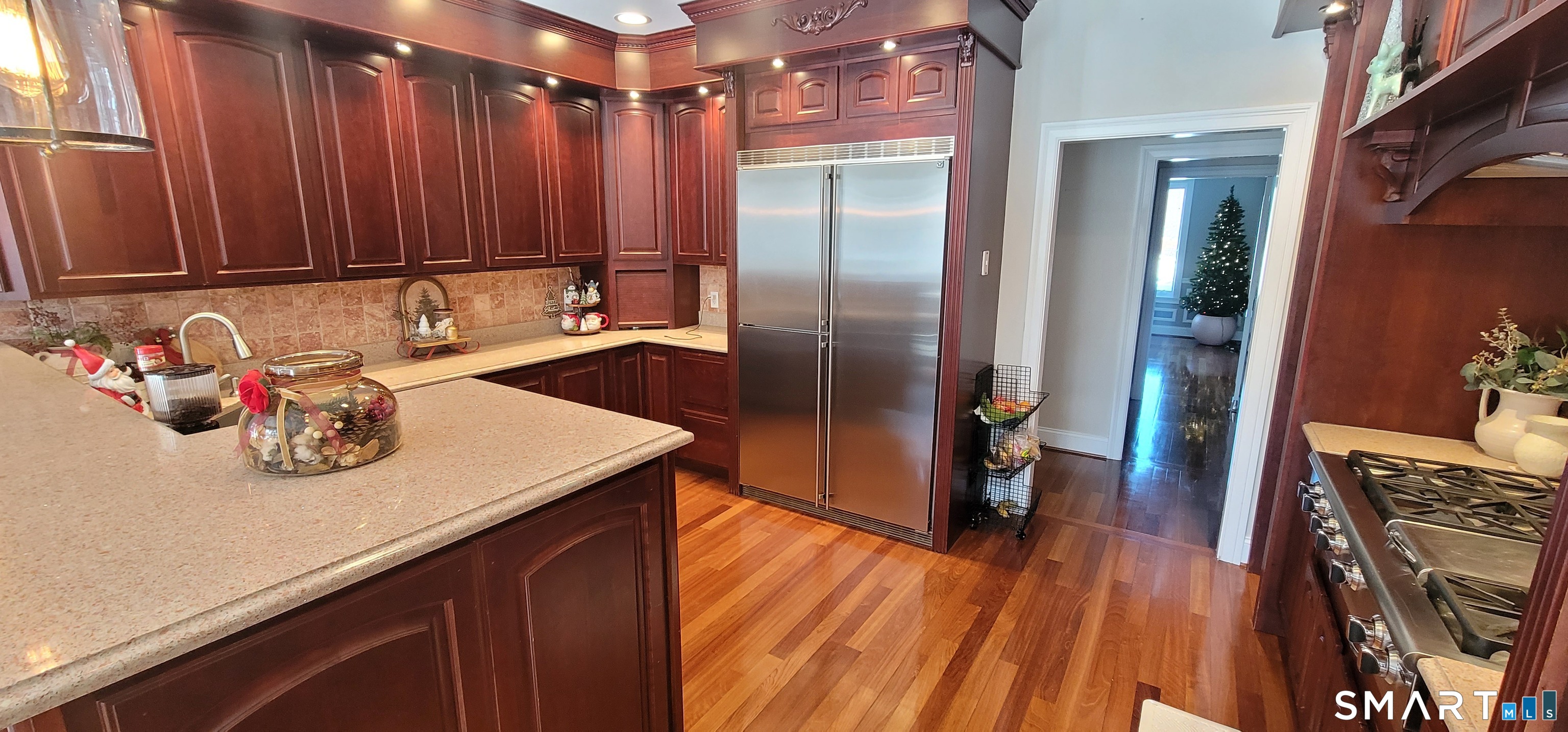 1461 Bunker Hill Road Watertown, CT 06795 - Photo 15 of 22 a kitchen with stainless steel appliances wooden floor window and wooden cabinets