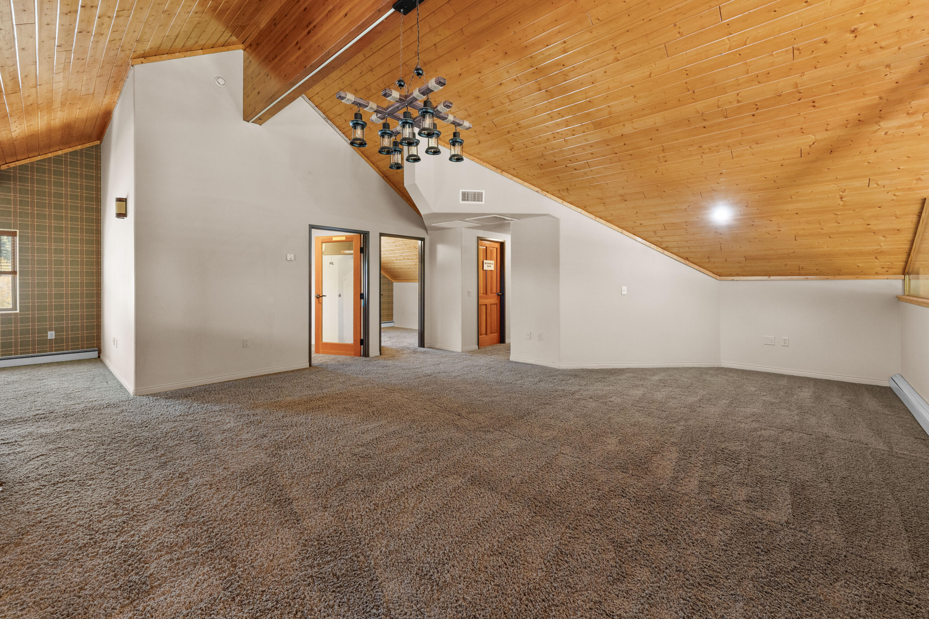 42718 Moonridge Road Big Bear Lake, CA 92315 - Photo 22 of 27 a view of an empty room with a chandelier