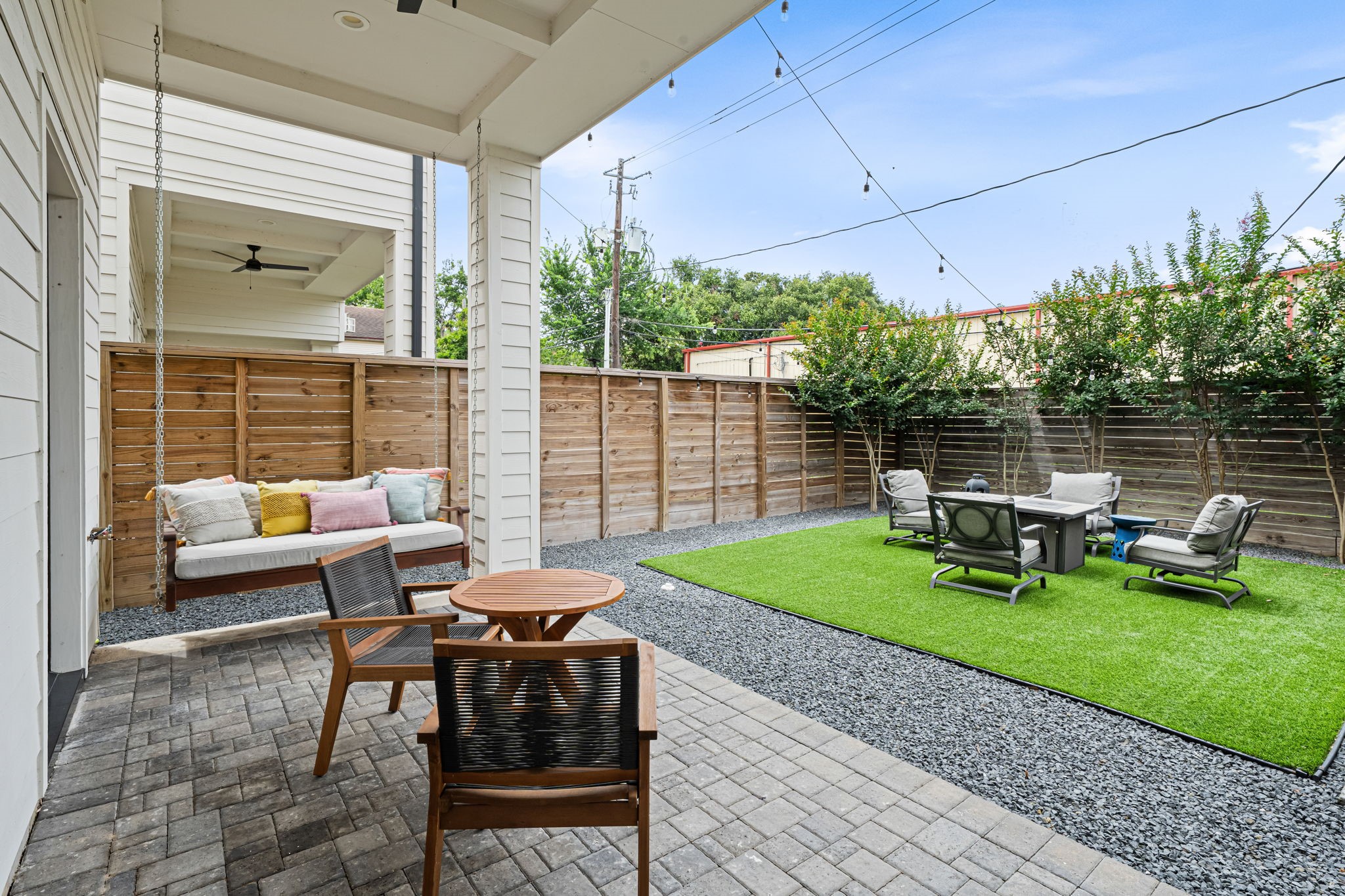 533 West 27th Street Houston, TX 77008 - Photo 9 of 22 Designed for easy outdoor living, the covered patio opens to an oversized turfed backyard lined by crepe myrtles, creating a private and low-maintenance extension of the home.