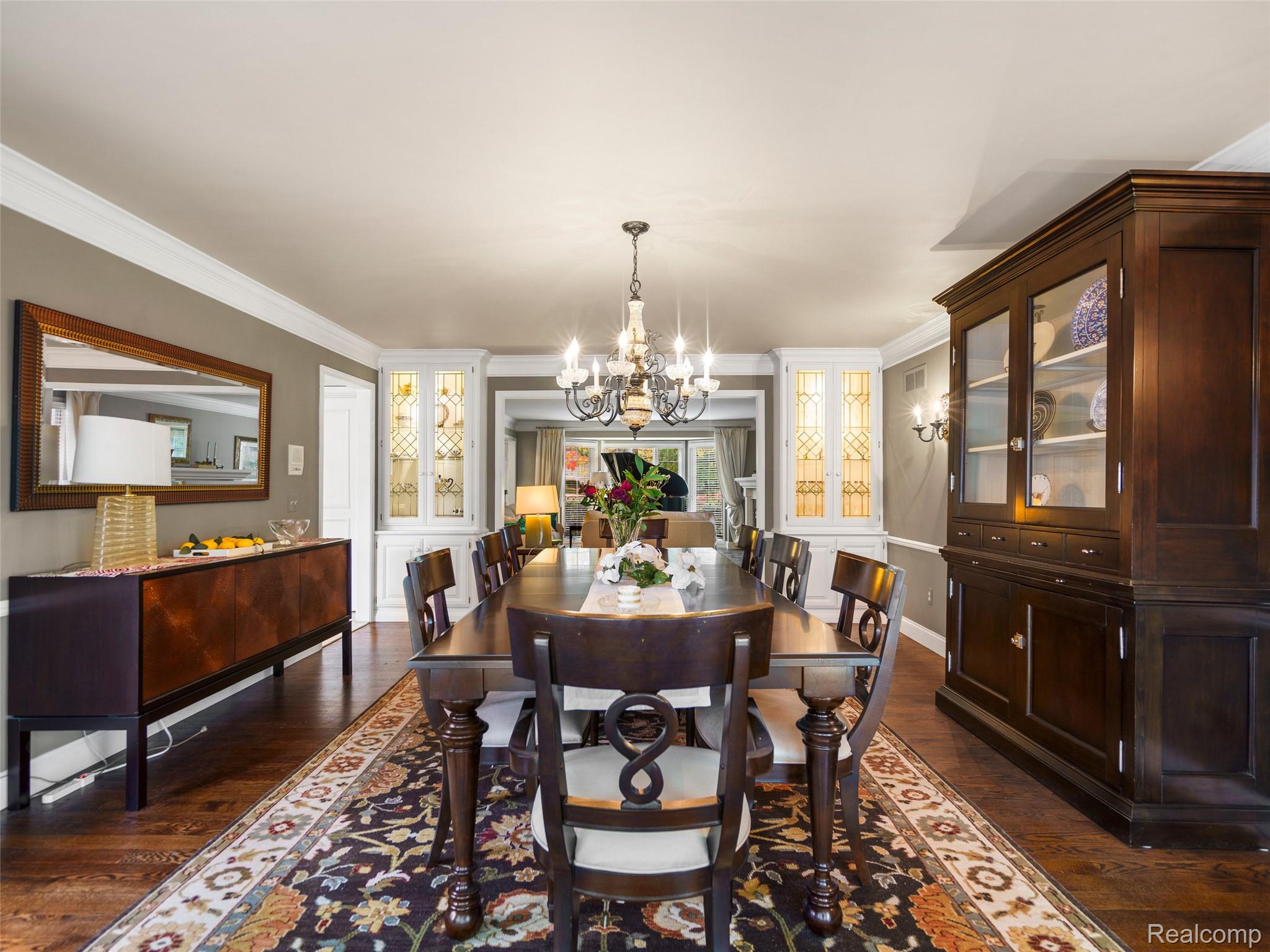 5724 Murfield Drive Rochester, MI 48306 - Photo 45 of 99 Dining area with ornamental molding, dark wood finished floors, and a chandelier