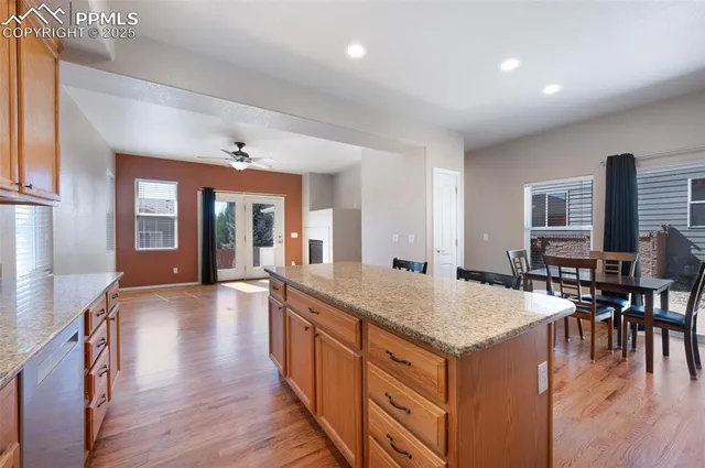 a view of living room kitchen island dining table and wooden floor