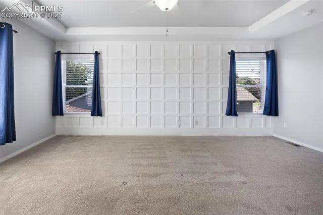 an empty room with windows and closet