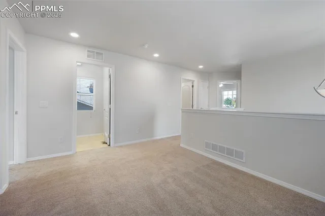 an empty room with windows and closet