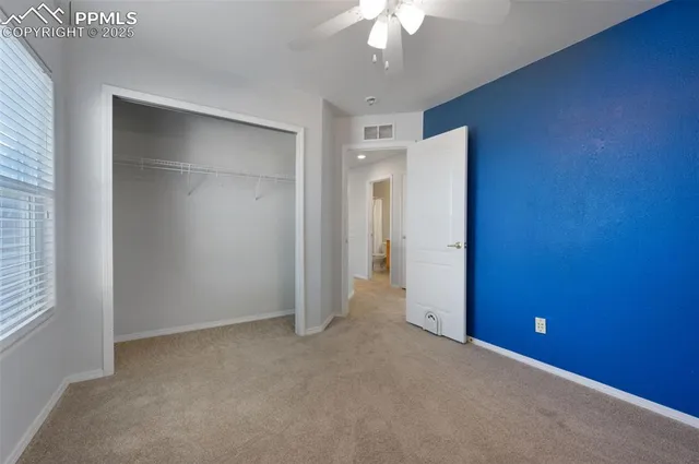 an empty room with a empty space and a ceiling fan