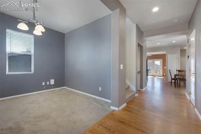 a view of a room with wooden floor and windows