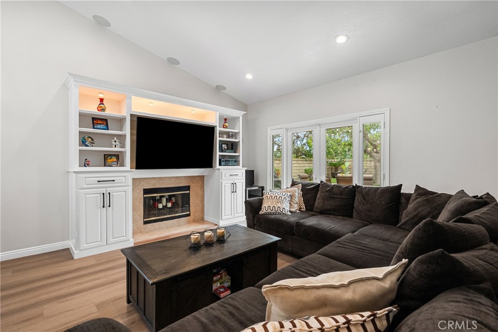27251 Blakely Place Valencia, CA 91354 - Photo 12 of 31 a living room with furniture a fireplace and a flat screen tv