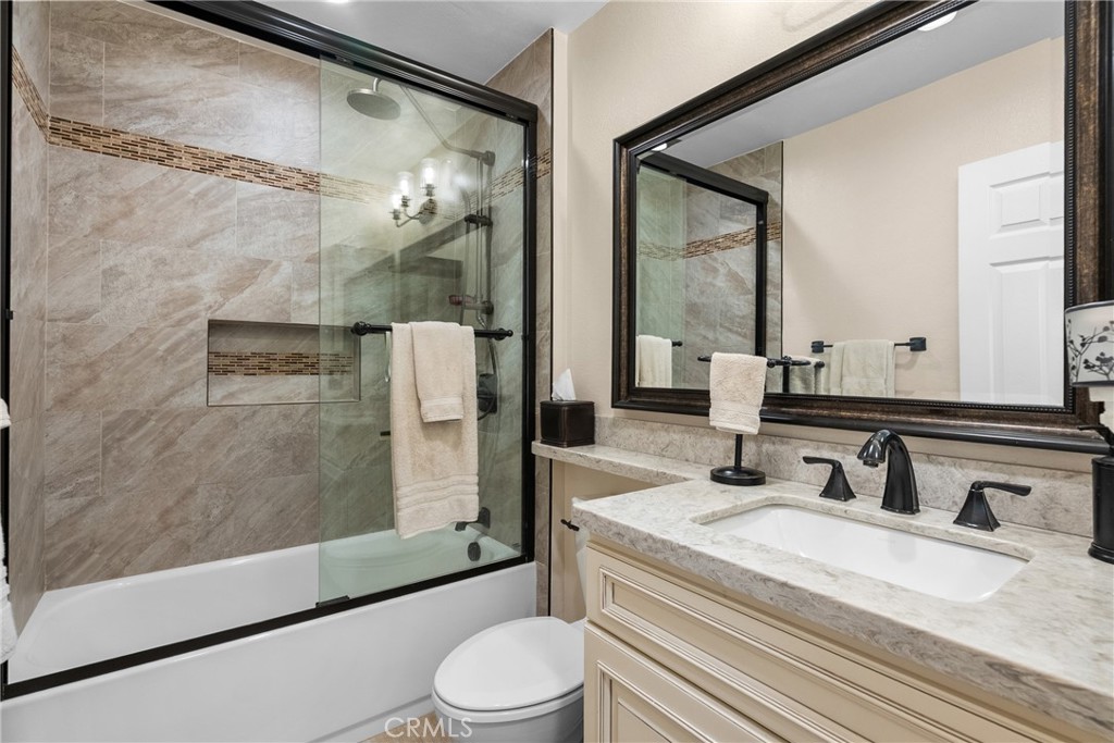 27251 Blakely Place Valencia, CA 91354 - Photo 14 of 31 a bathroom with a granite countertop sink toilet and shower