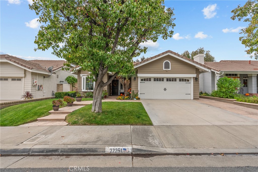 27251 Blakely Place Valencia, CA 91354 - Photo 28 of 31 a front view of a house with garage and plants