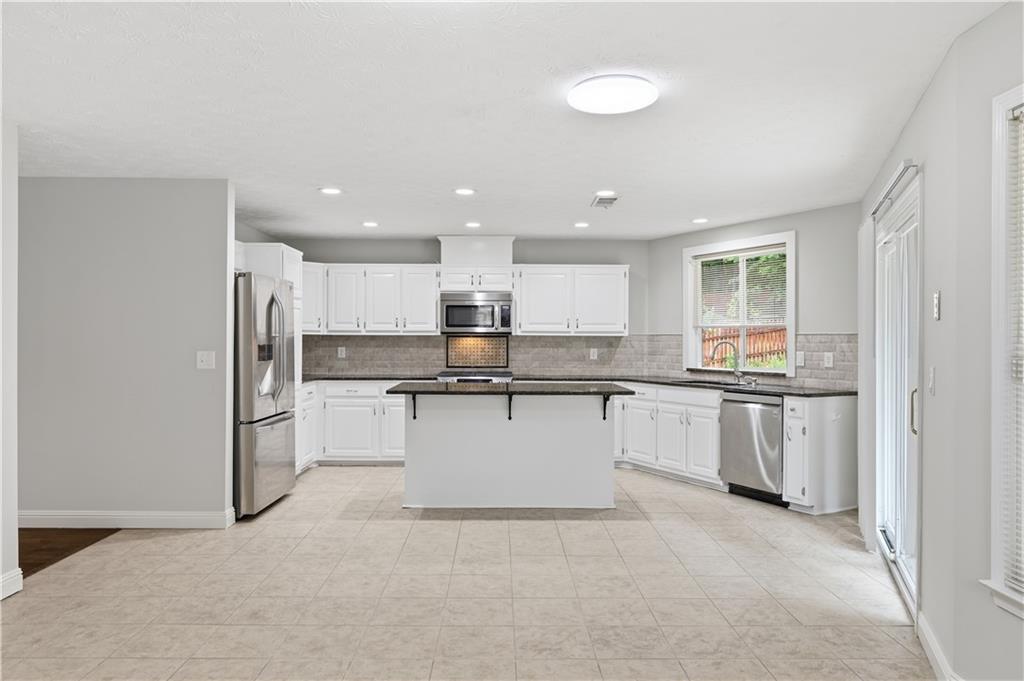 2824 Carriage Rowe Duluth, GA 30096 - Photo 13 of 45 a kitchen with a refrigerator and white cabinets