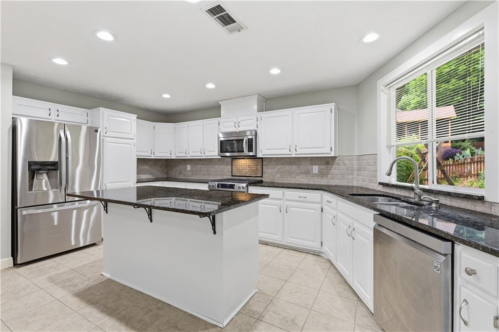 2824 Carriage Rowe Duluth, GA 30096 - Photo 15 of 45 a kitchen with stainless steel appliances granite countertop a stove a sink and a refrigerator