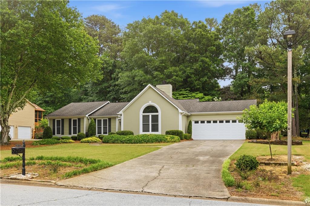 2824 Carriage Rowe Duluth, GA 30096 - Photo 2 of 45 a front view of a house with a garden