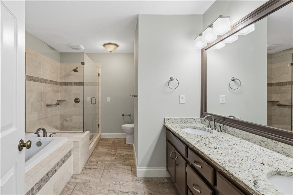 2824 Carriage Rowe Duluth, GA 30096 - Photo 21 of 45 a spacious bathroom with a granite countertop tub sink and mirror