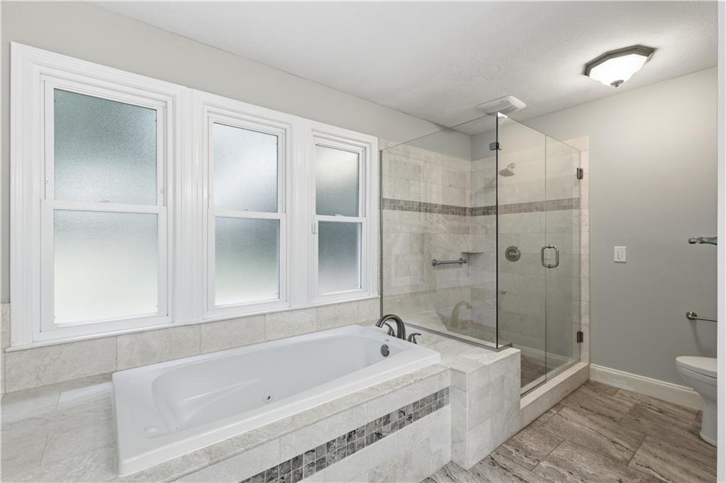 2824 Carriage Rowe Duluth, GA 30096 - Photo 22 of 45 a bathroom with a bathtub and a shower