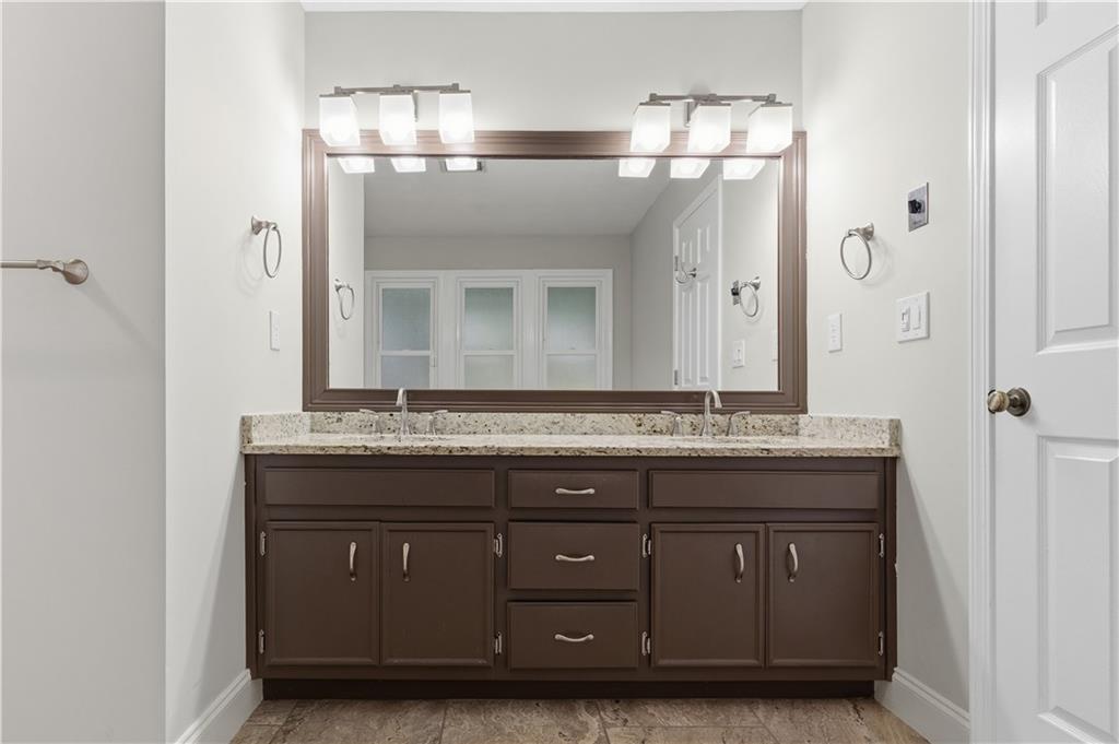 2824 Carriage Rowe Duluth, GA 30096 - Photo 24 of 45 a bathroom with a granite countertop sink a mirror and a shower