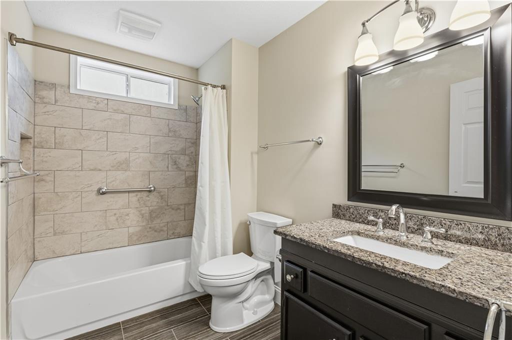 2824 Carriage Rowe Duluth, GA 30096 - Photo 28 of 45 a bathroom with a granite countertop sink toilet and shower