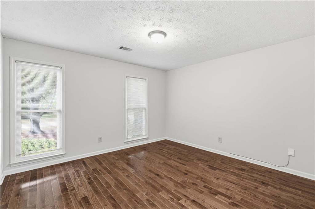 2824 Carriage Rowe Duluth, GA 30096 - Photo 29 of 45 a view of empty room with wooden floor and fan