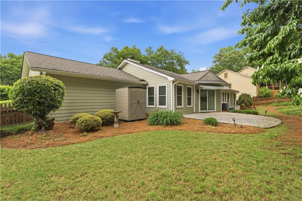 2824 Carriage Rowe Duluth, GA 30096 - Photo 32 of 45 a view of a house with a backyard and a tree