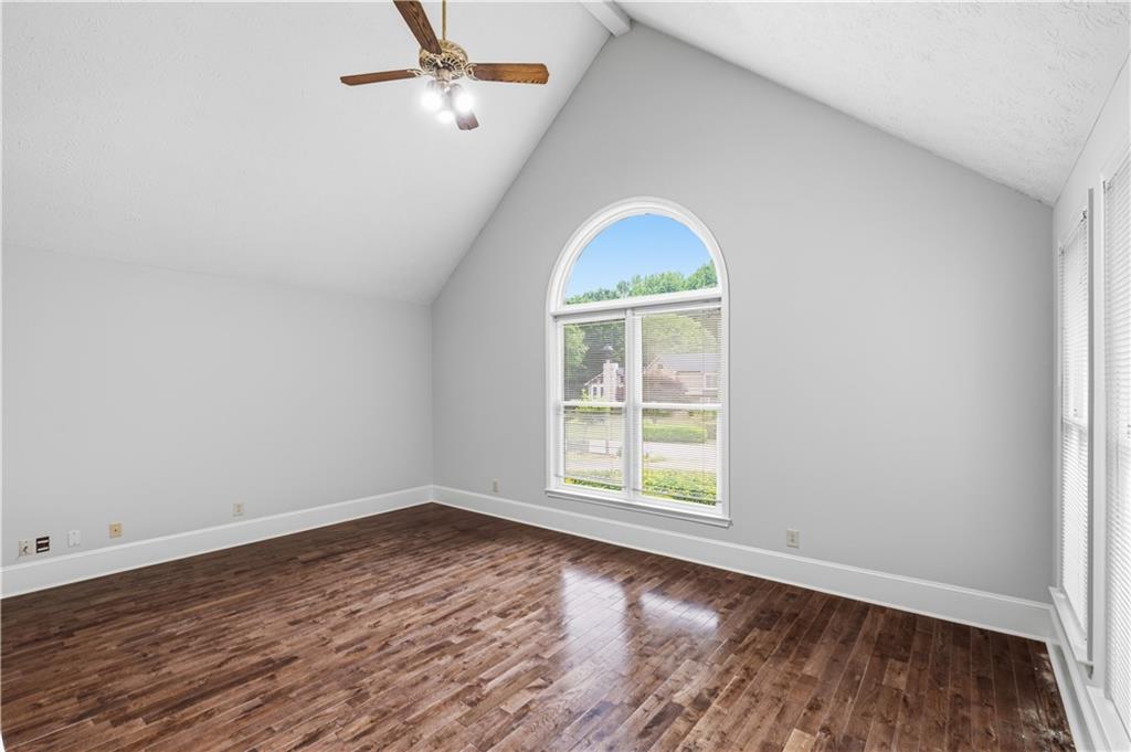2824 Carriage Rowe Duluth, GA 30096 - Photo 6 of 45 an empty room with wooden floor cabinet and windows