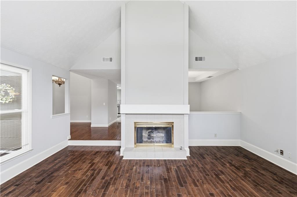 2824 Carriage Rowe Duluth, GA 30096 - Photo 7 of 45 a view of a livingroom with wooden floor and a fireplace