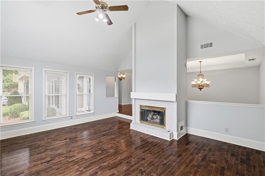 2824 Carriage Rowe Duluth, GA 30096 - Photo 8 of 45 a view of a livingroom with wooden floor a fireplace and windows